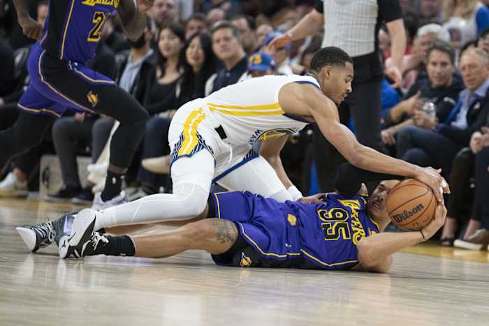 October 18, 2022; San Francisco, California, USA; Golden State Warriors guard Jordan Poole (3) and Los Angeles Lakers forward Juan Toscano-Anderson (95) fight for the ball during the third quarter at Chase Center. Mandatory Credit: Kyle Terada-USA TODAY Sports